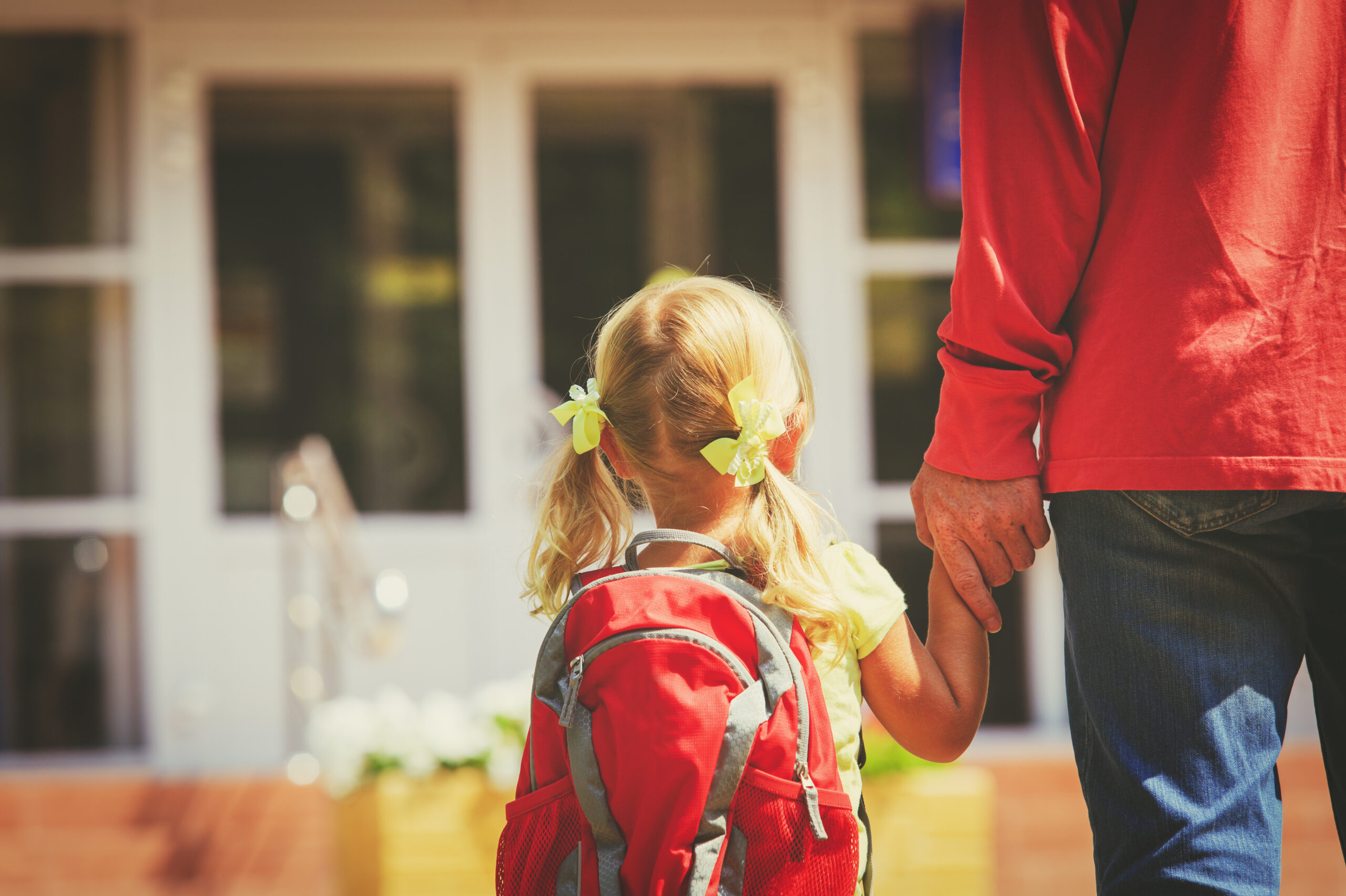 Child walking into Daycare with mom.