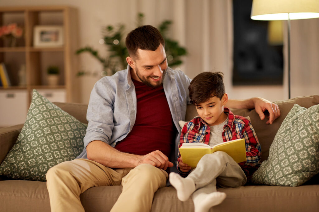 Child and Father Reading Together. Reset. 