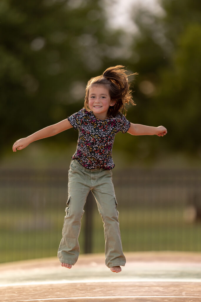 Girl jumping on jumping pillow