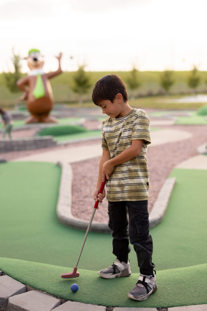 Boy playing Mini golf