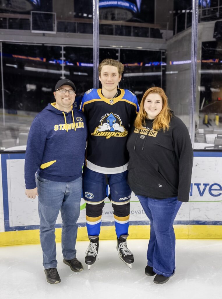 Billet Family and Player on the Ice