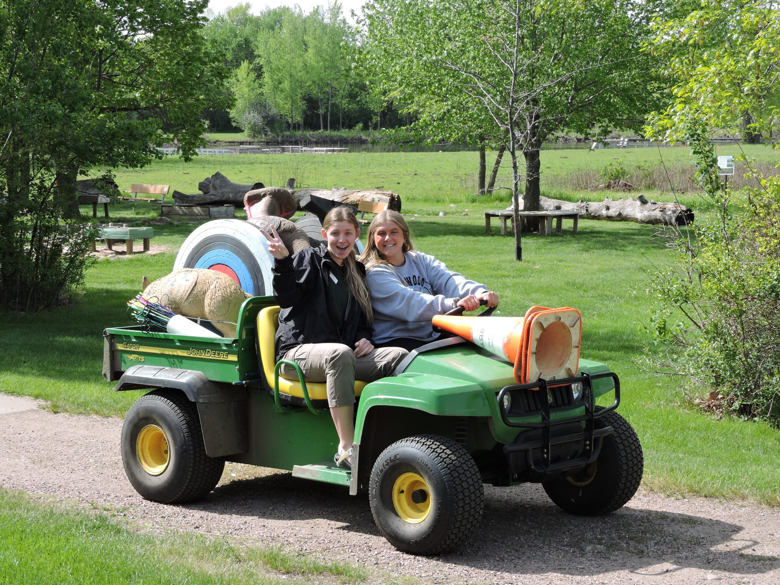 Two women on an Outdoor Campus vehicle