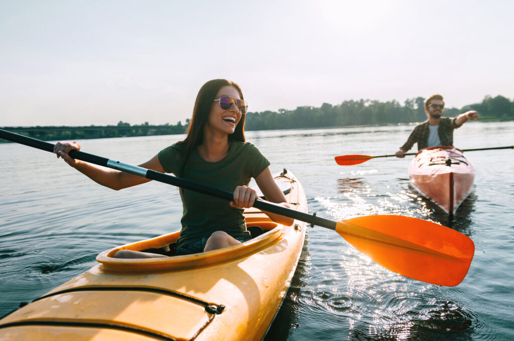 Couple kayaking together. Beautiful young couple kayaking on lak