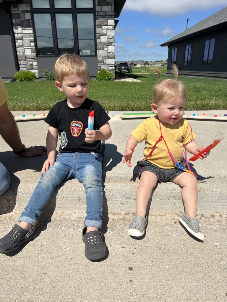 Two young children eating a popsical at Familyfest